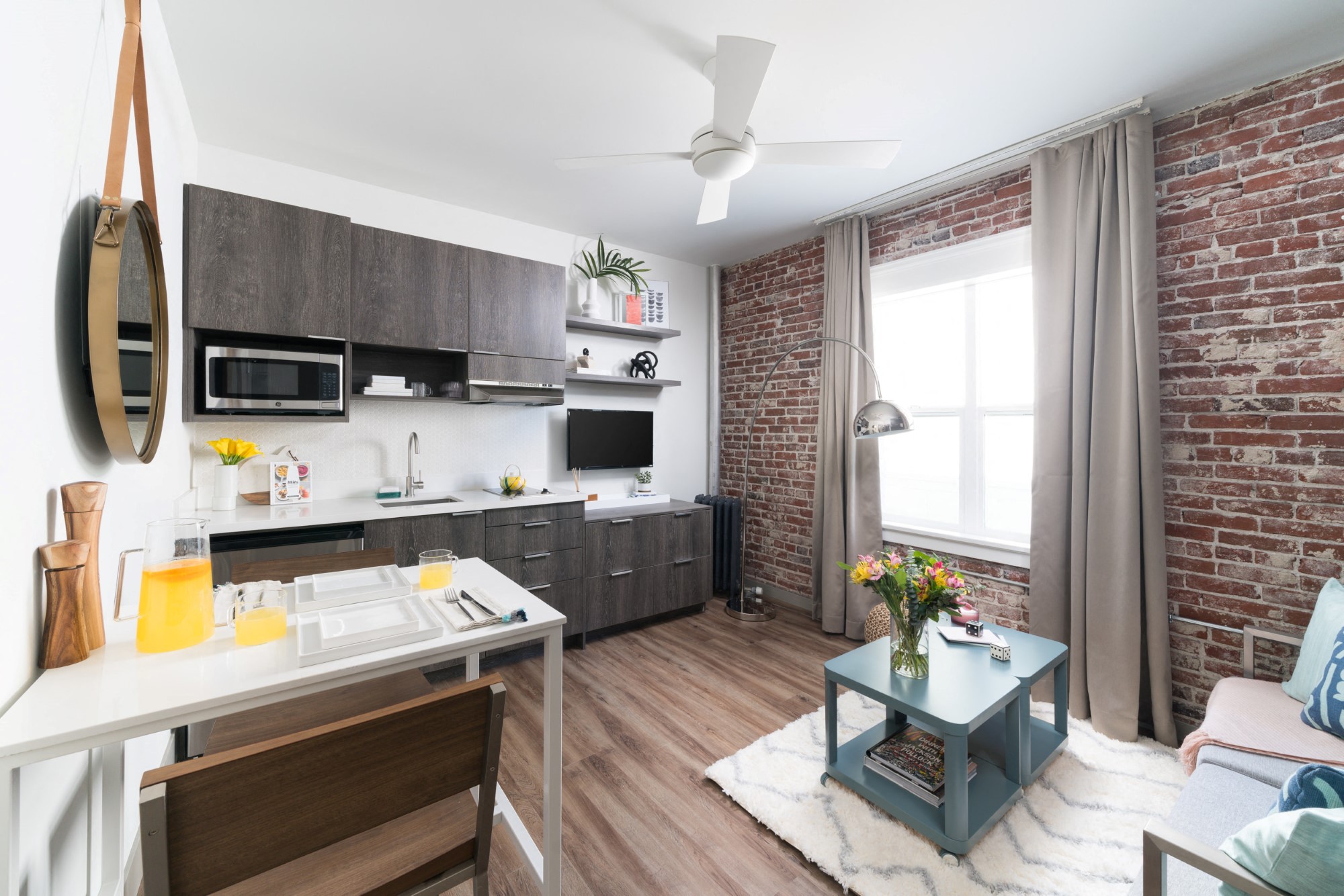 A kitchen with a dining table and chairs.