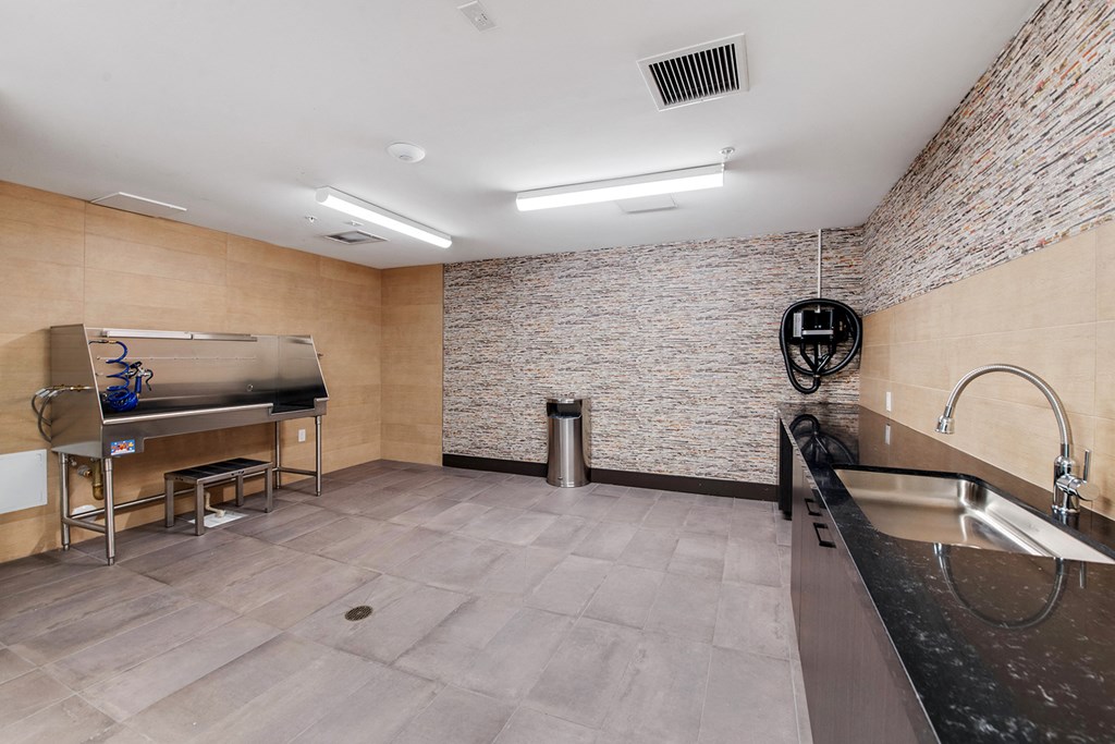 a large kitchen with a sink and a refrigerator