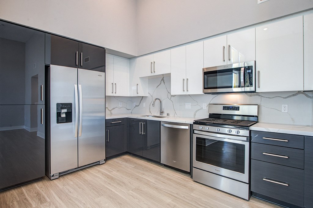 a kitchen with stainless steel appliances and white cabinets