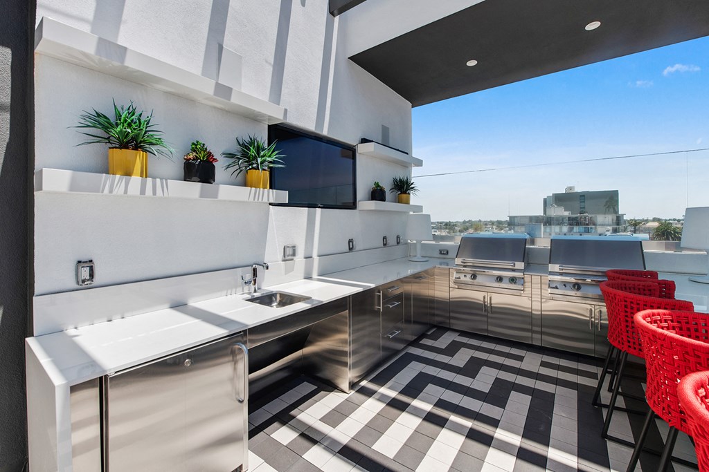 a kitchen with stainless steel appliances and a checkered floor
