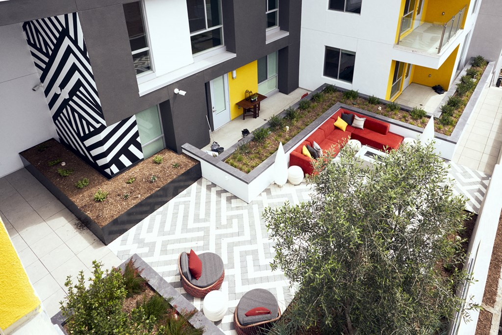 an aerial view of the courtyard of a building with a red couch