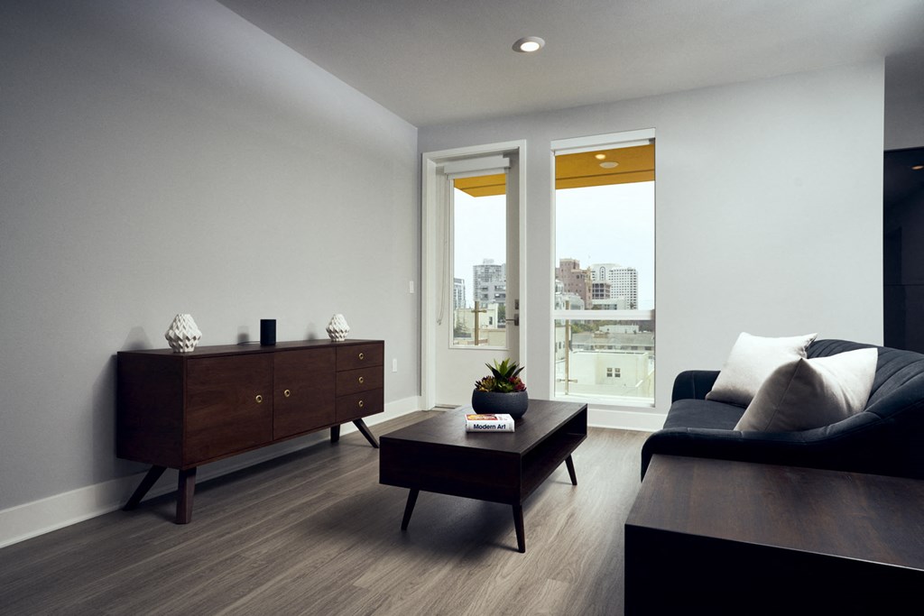 a living room with a black couch and a coffee table