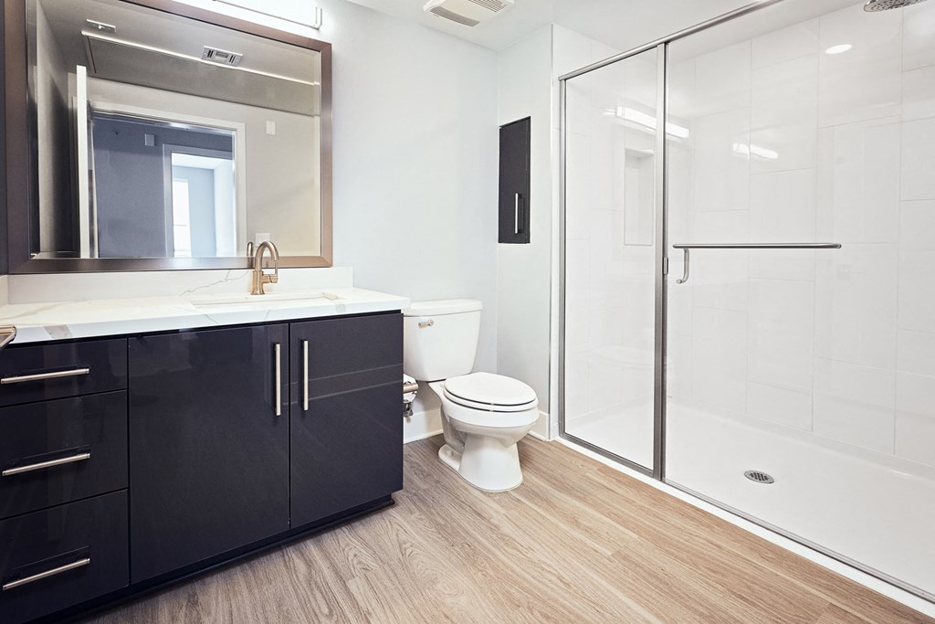 a bathroom with a toilet and a sink and a shower