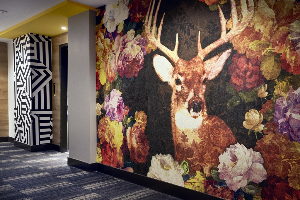 a mural of a deer and flowers on a wall