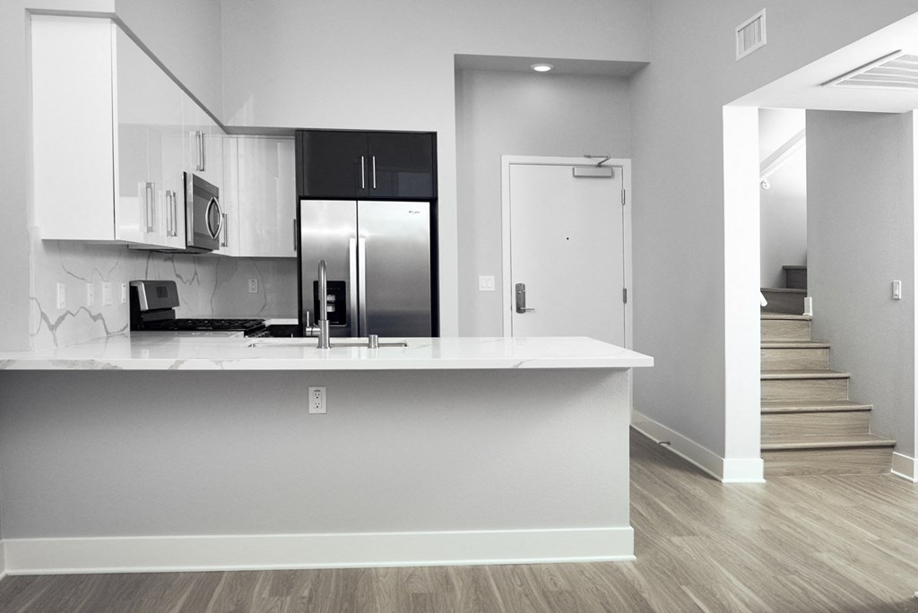 a kitchen with a counter top and a refrigerator