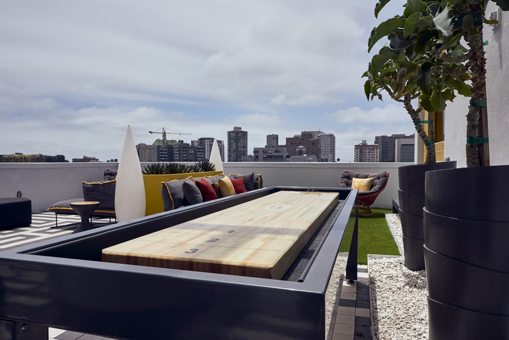 a rooftop lounge area with a city skyline in the background