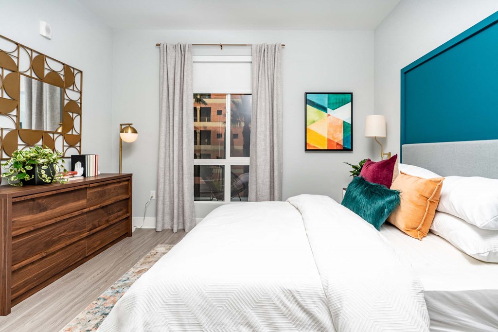 a bedroom with a large bed and a window