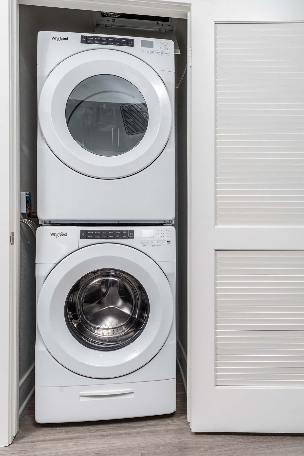 a white washer and dryer in a white closet