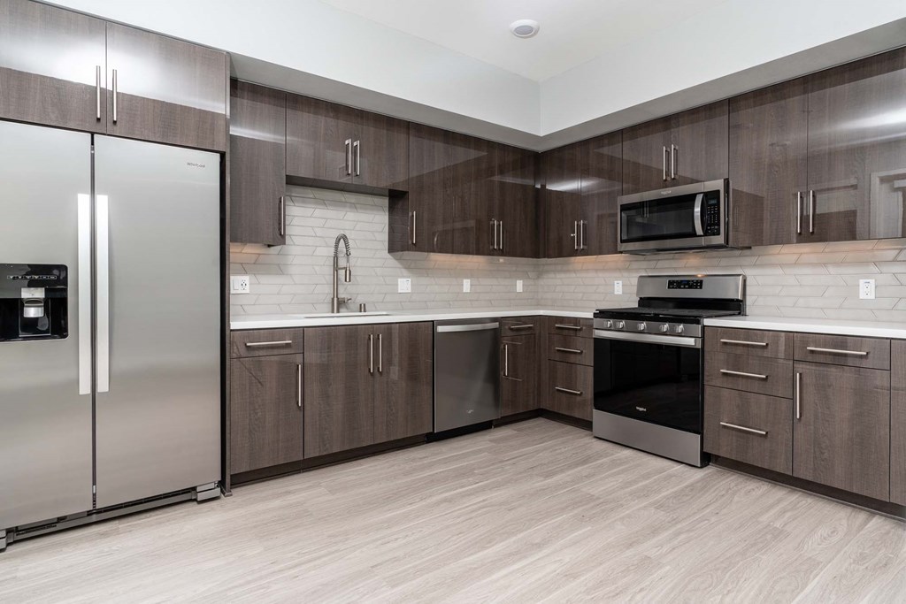 a kitchen with stainless steel appliances and wooden cabinets