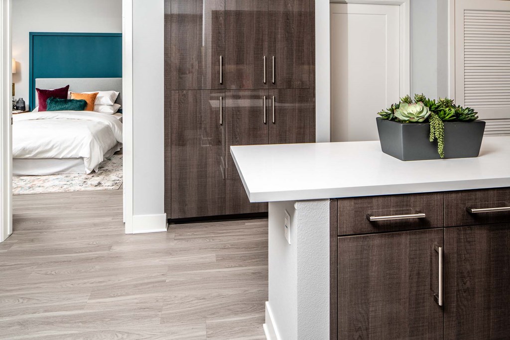 a kitchen with brown cabinets and a white counter top