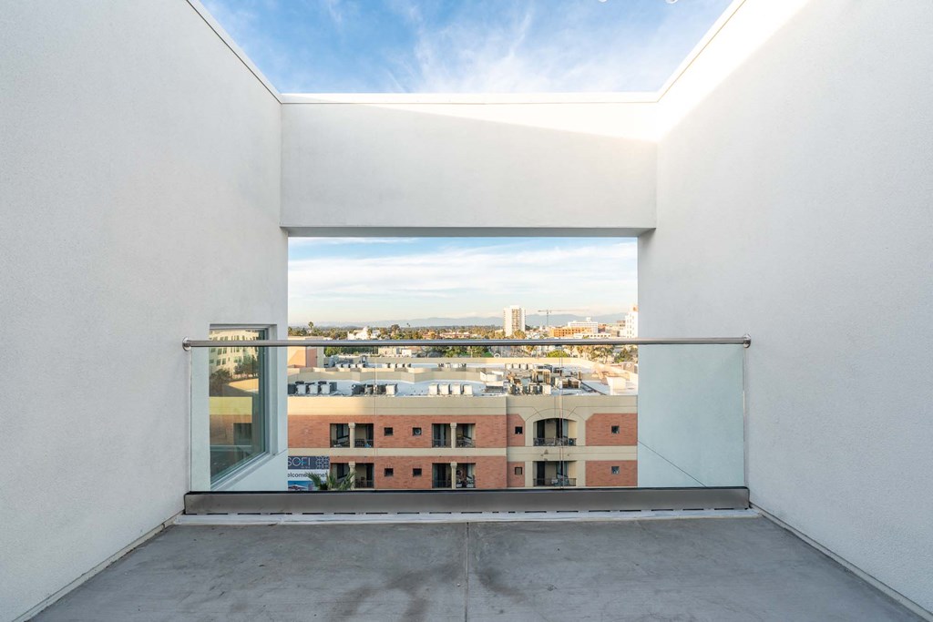 a room with a balcony and a view of a city