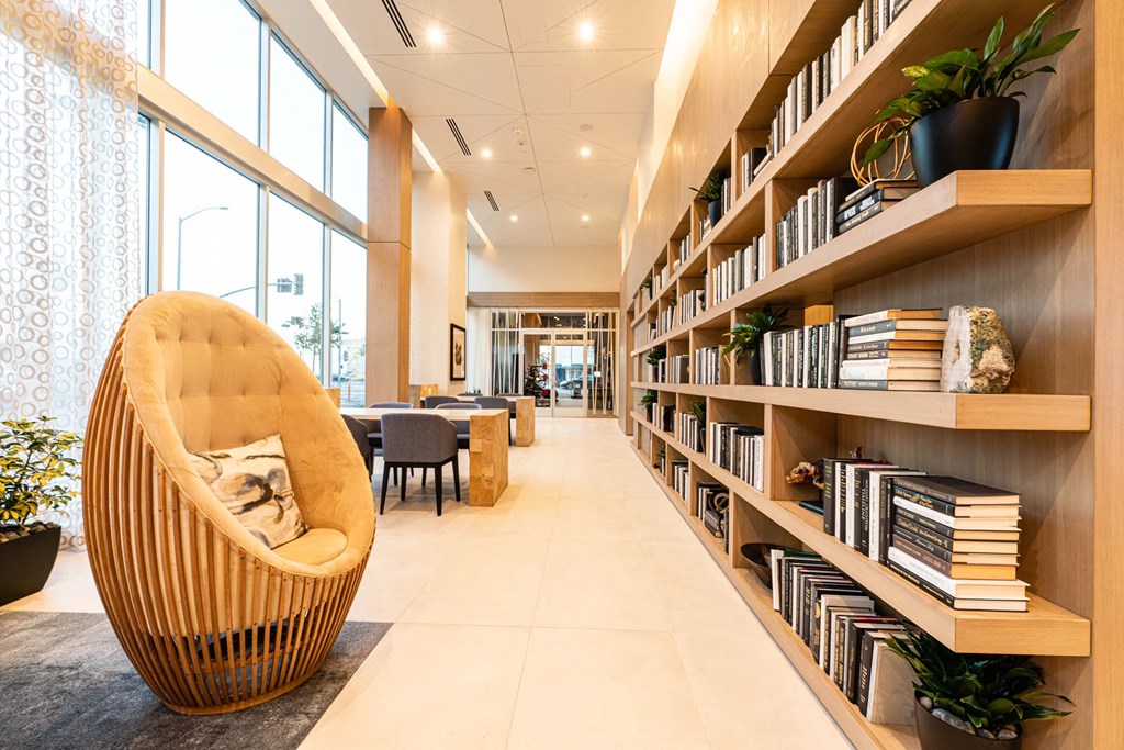 a large library with a chair and shelves of books