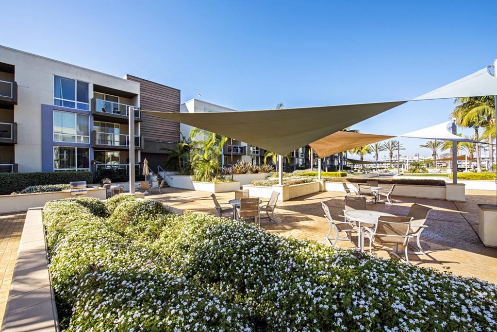 a patio with tables and chairs and umbrellas