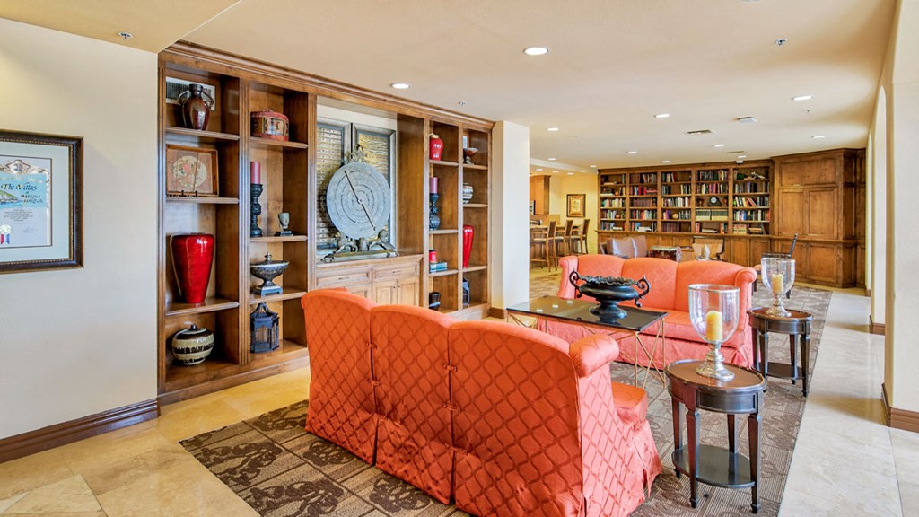 a living room filled with furniture and a book shelf