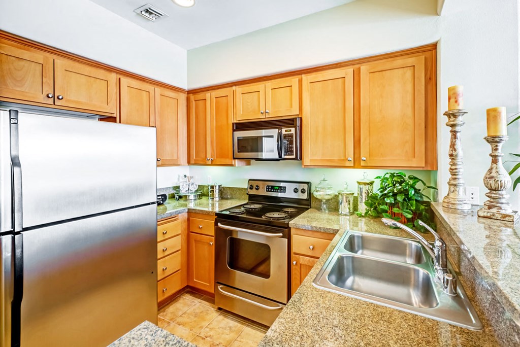 a kitchen with stainless steel appliances and granite counter tops