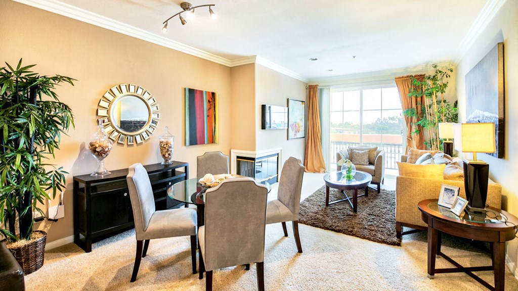 a living room with a table and chairs and a fireplace