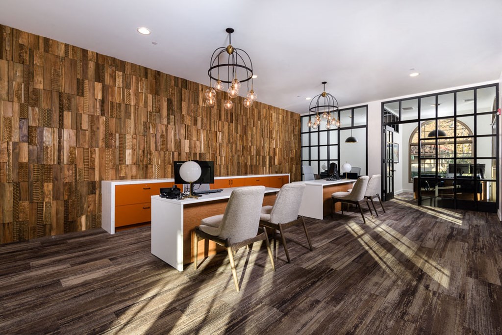 a conference room with a desk and chairs and a large window