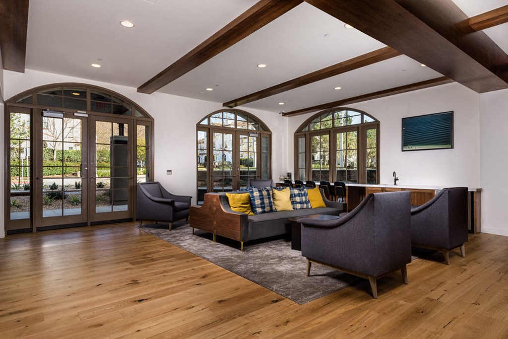 a living room with furniture and large windows