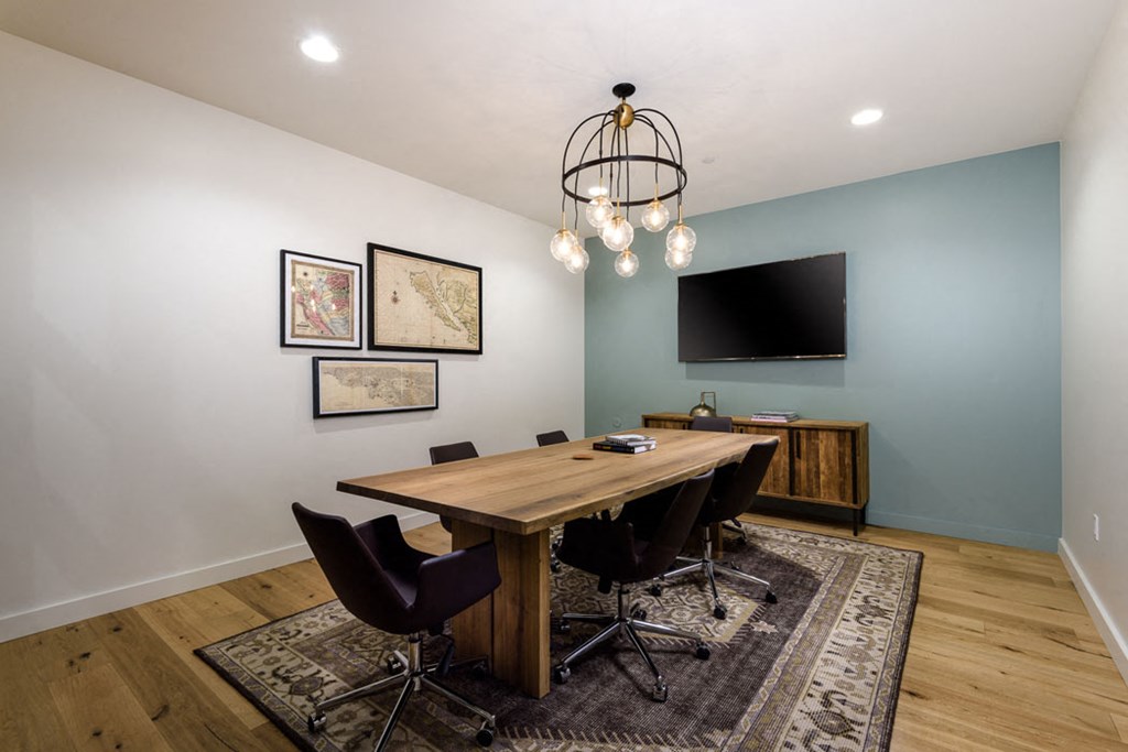 a dining room with a table and chairs and a television