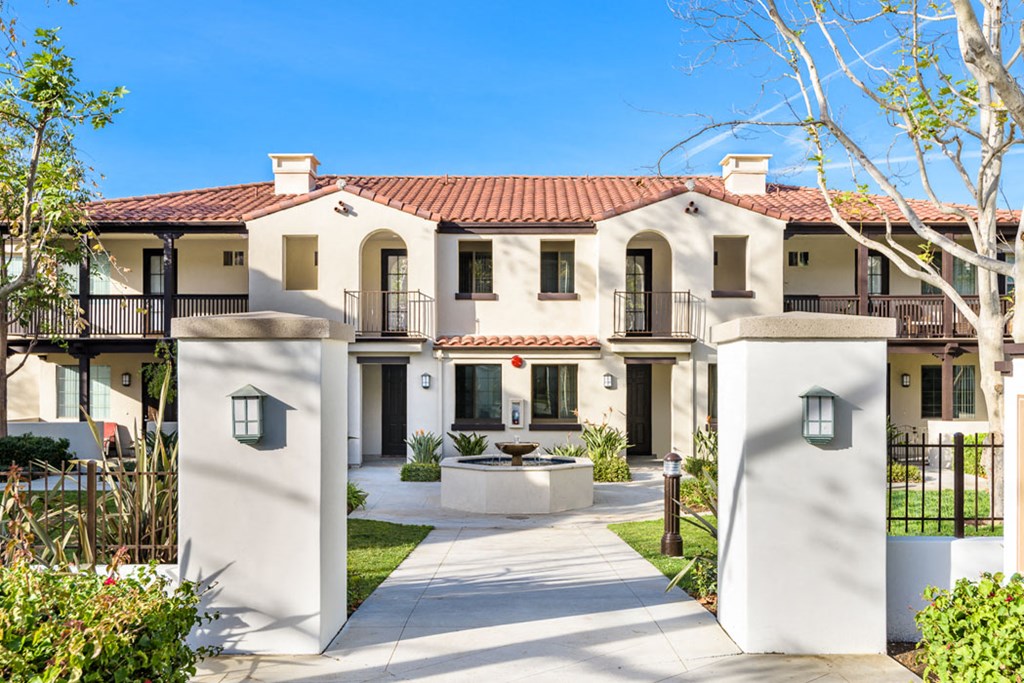 a white house with a courtyard and a fountain