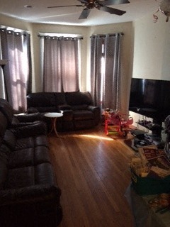a living room with couches and a wooden floor