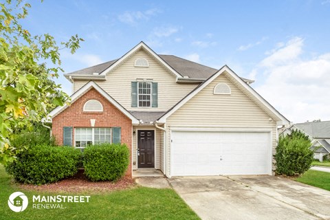 a home with a white garage door in front of it