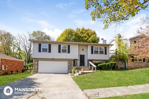 a white house with a driveway and a garage door