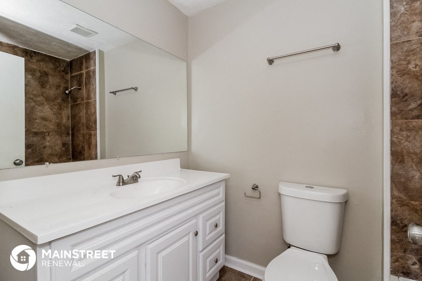 a bathroom with a white sink and a mirror and a toilet