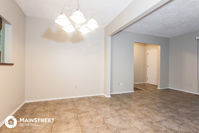 the living room and dining room of an empty house