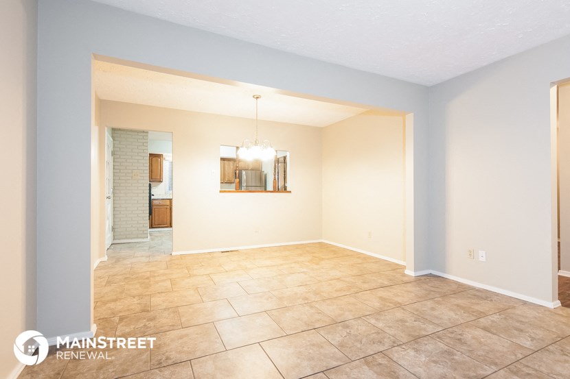 the living room and dining room with tile flooring