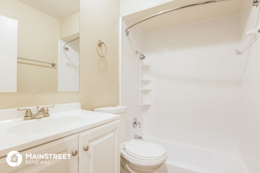 a bathroom with a sink and a toilet and a shower