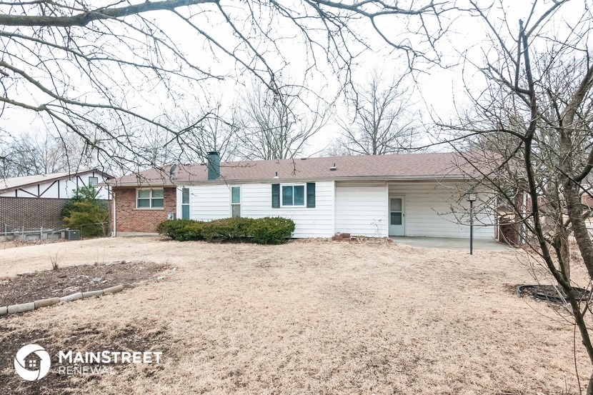 a white house with a yard in front of it