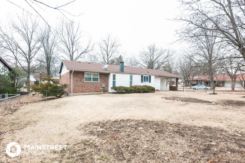 a house with a dirt lot in front of it