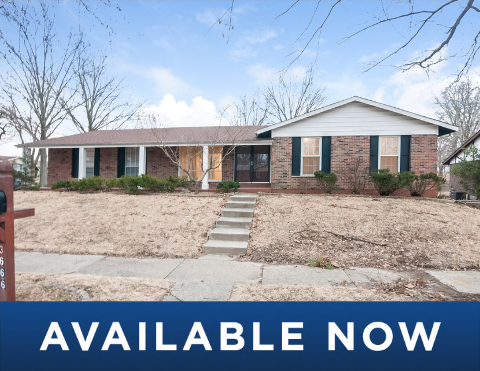a small brick house with a yard and stairs