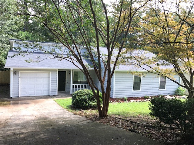 a white house with a tree in front of it