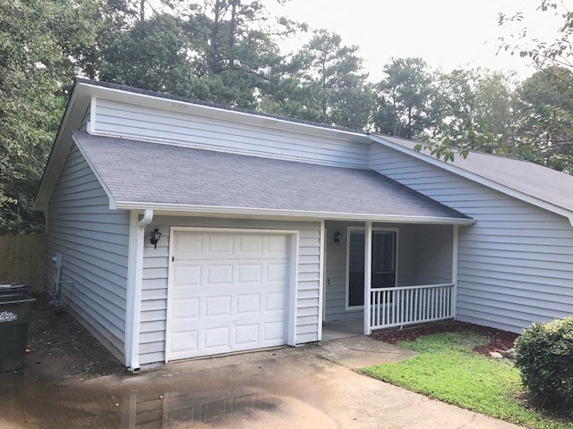 a white house with a white garage door