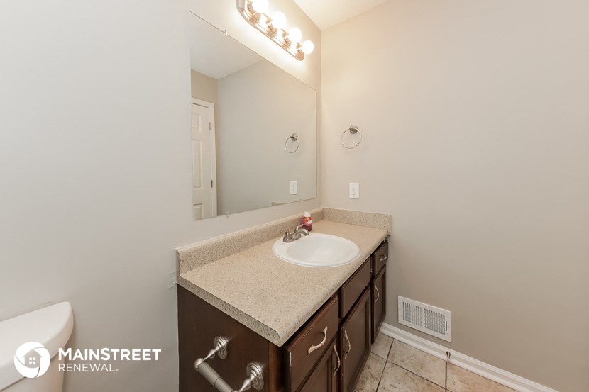 a bathroom with a sink and a mirror and a toilet