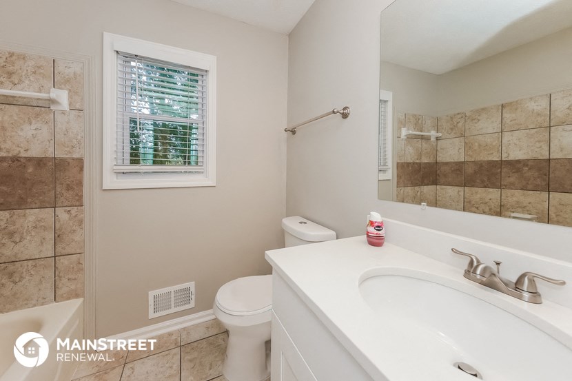 a bathroom with a sink and a toilet and a mirror