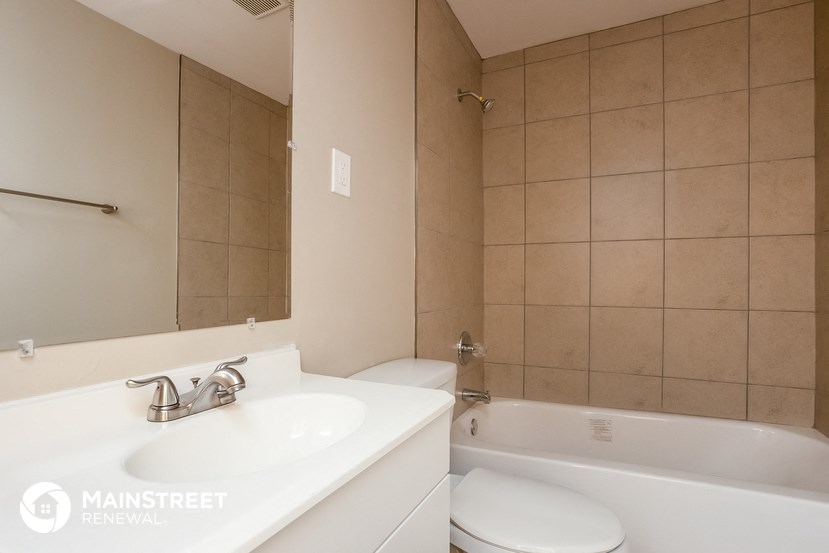 a bathroom with a sink and a tub and a toilet