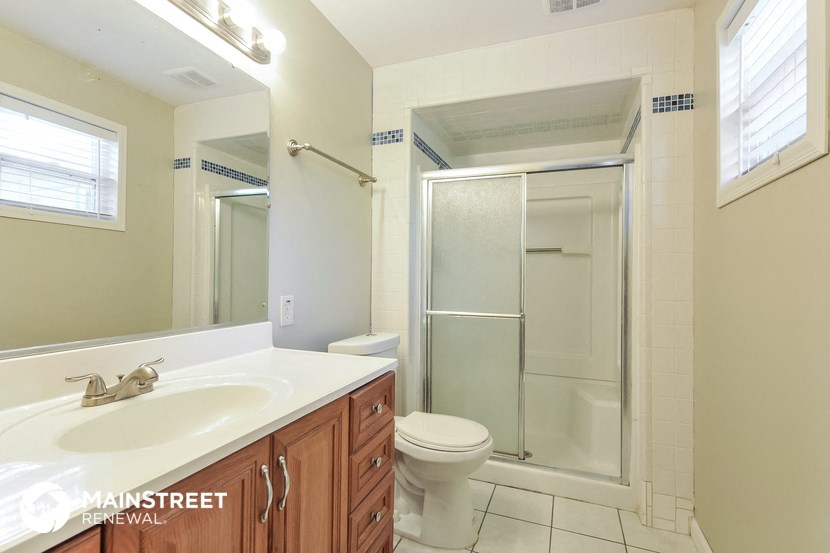 a bathroom with a sink and a shower and a toilet
