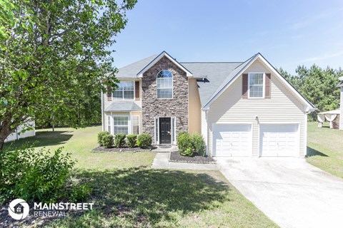 a home with a white garage door and a white house