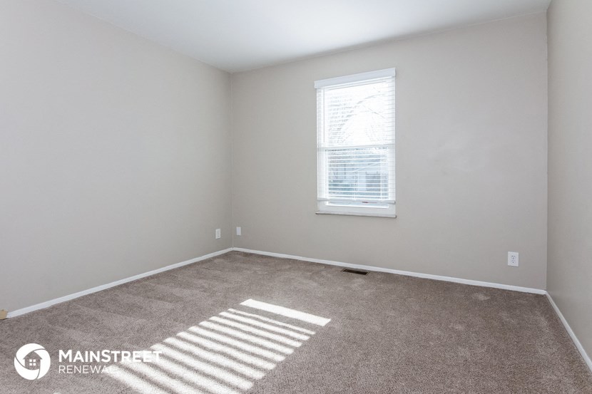 a room with carpet and a window