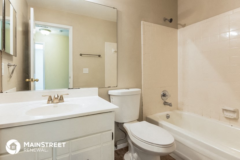 a bathroom with a sink toilet and a tub