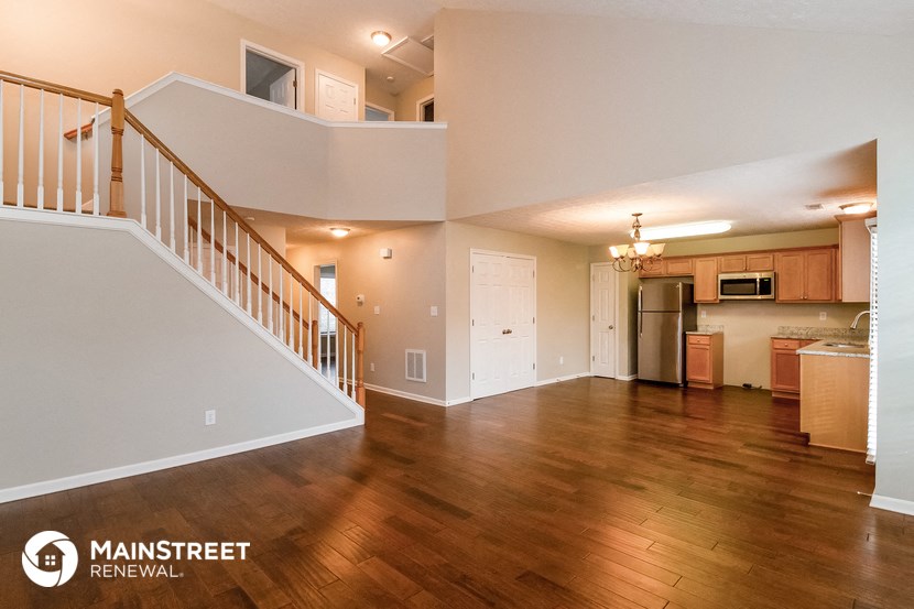 the view of the living room and kitchen from the dining room