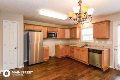 a kitchen with wooden cabinets and stainless steel appliances