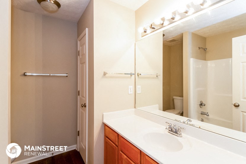 a bathroom with a large mirror and a sink