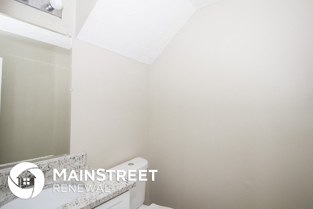 a small bathroom with a toilet and a mirror