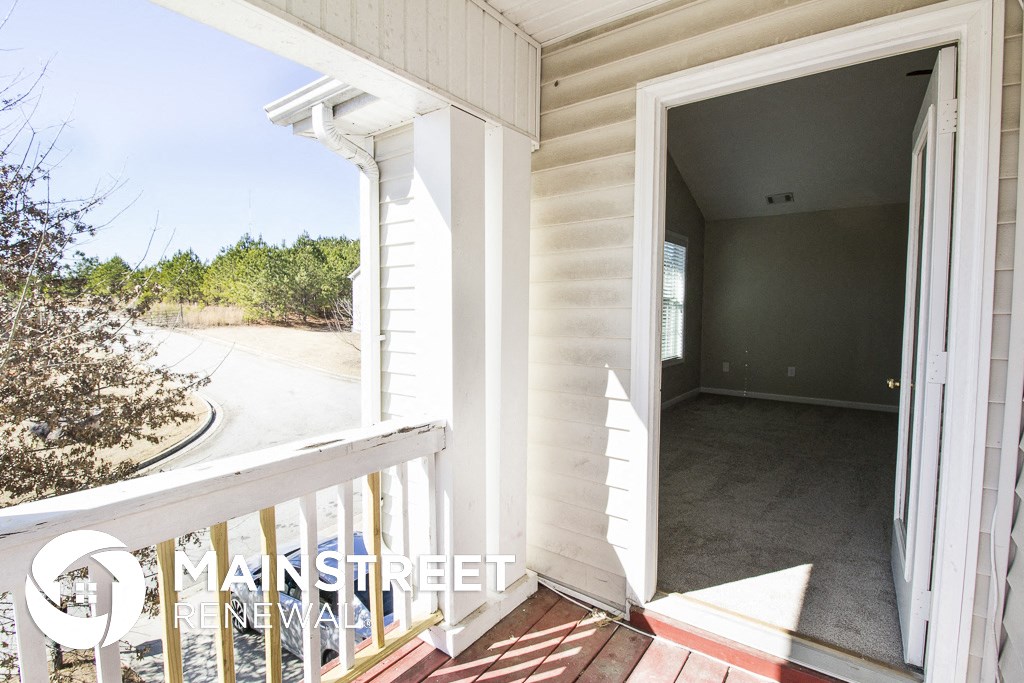 a view of the front door of a house from a balcony