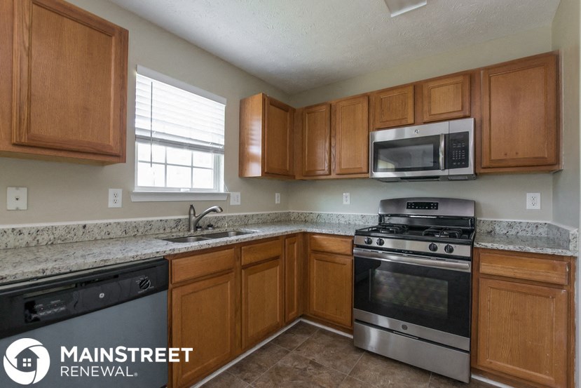 a kitchen with stainless steel appliances and wooden cabinets