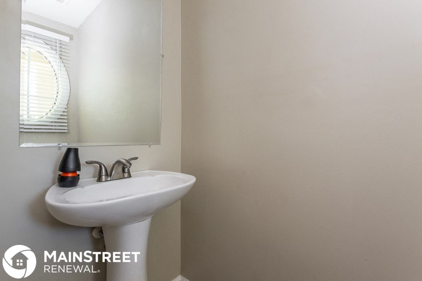 a small bathroom with a sink and a mirror